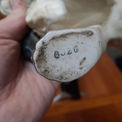 1080 - Pair of German porcelain modelled spaniel dogs, seated and naturalistically painted in grey and whit... 