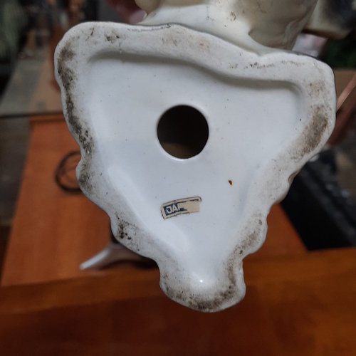 1080 - Pair of German porcelain modelled spaniel dogs, seated and naturalistically painted in grey and whit... 