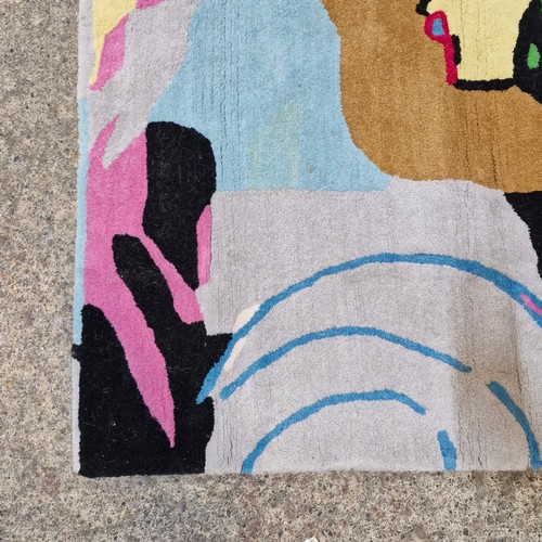 A vibrant modern rug featuring a bold abstract painterly composition ...