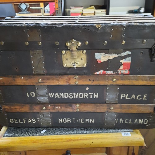 434 - Star Lot : An antique canvas-covered  travelling trunk with timber battens and brass studding, iron ... 