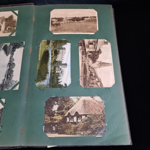 102 - Star Lot : A large postcard album holding a large array of vintage and antique postcards. Lot includ... 