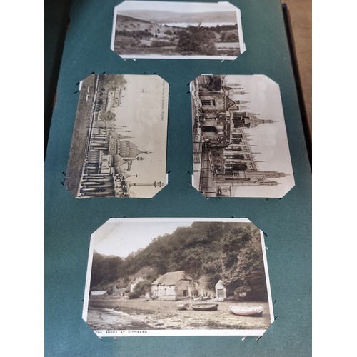 102 - Star Lot : A large postcard album holding a large array of vintage and antique postcards. Lot includ... 