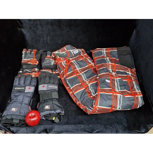 402 - A group of winter sports outerwear, comprising a red, grey and black tartan-patterned jacket, matchi... 