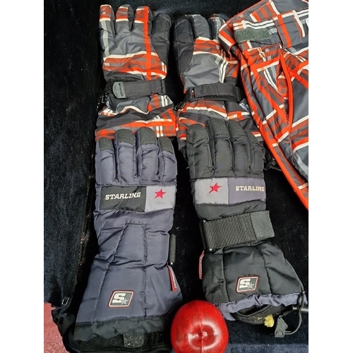 402 - A group of winter sports outerwear, comprising a red, grey and black tartan-patterned jacket, matchi... 