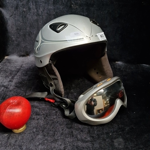 403 - 2 CEBE winter sports items comprising a silver-tone ski/snowboard helmet with padded ear flaps and a... 