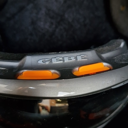 403 - 2 CEBE winter sports items comprising a silver-tone ski/snowboard helmet with padded ear flaps and a... 