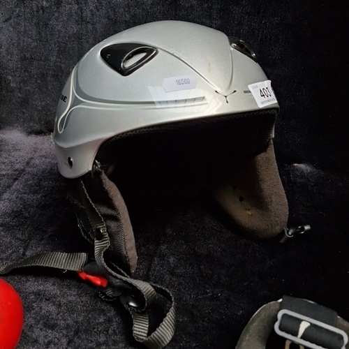 403 - 2 CEBE winter sports items comprising a silver-tone ski/snowboard helmet with padded ear flaps and a... 
