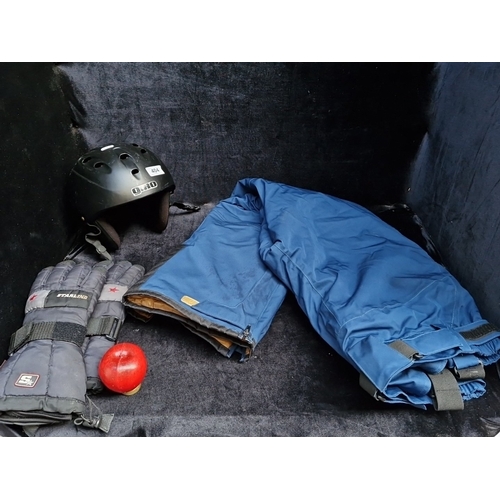 404 - A group of winter sports accessories comprising a Giro vented helmet, Starling padded gloves, and bl... 