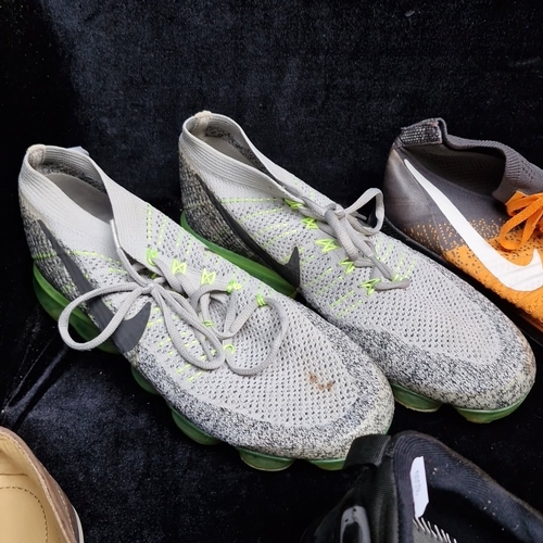 405 - A group of assorted footwear, comprising Nike Flyknit running shoes, Nike knit trainers, Adidas trai... 