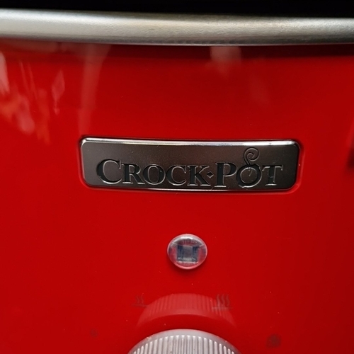 406 - A Crock-Pot electric slow cooker, model CSC037, in red with glass lid, removable ceramic insert, and... 