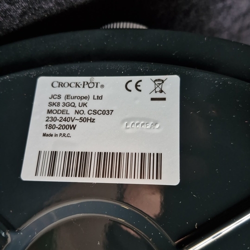 406 - A Crock-Pot electric slow cooker, model CSC037, in red with glass lid, removable ceramic insert, and... 