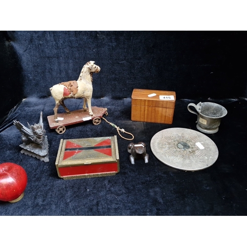 415 - A group of assorted decorative items, including an engraved circular metal salver, a small pewter mu... 