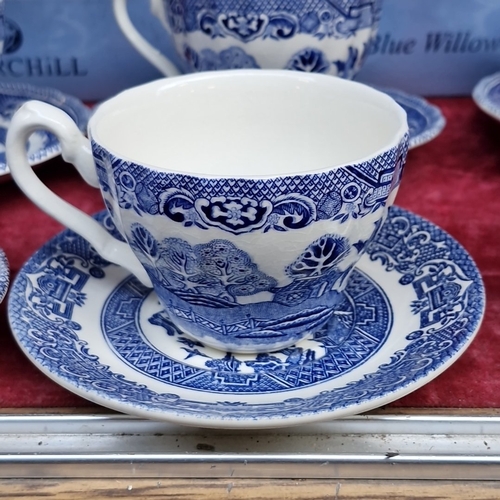 416 - A group of Churchill Blue Willow pattern blue-and-white tableware, including cups and saucers, dinne... 