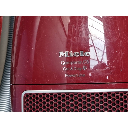 419 - A Miele Complete C3 “Cat & Dog” PowerLine canister vacuum cleaner, in maroon, with hose, telescopic ... 
