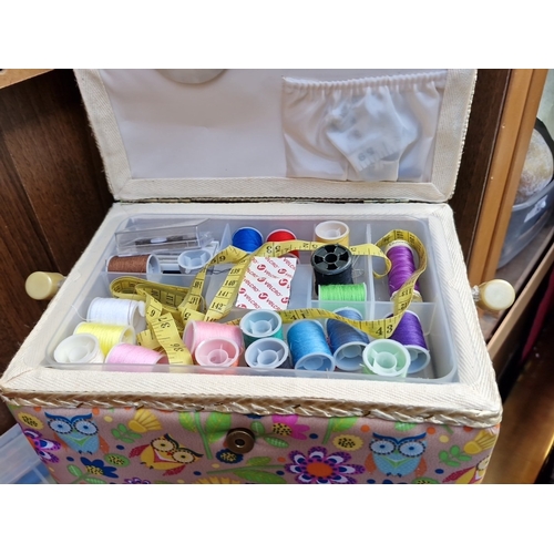422 - A group of sewing accessories, comprising a fabric-covered sewing box with compartmented tray and as... 