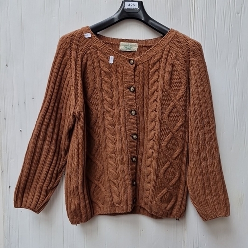 426 - A Blarney Woollen Mills Irish cable-knit wool cardigan, in rust-brown, with round neckline, long sle... 