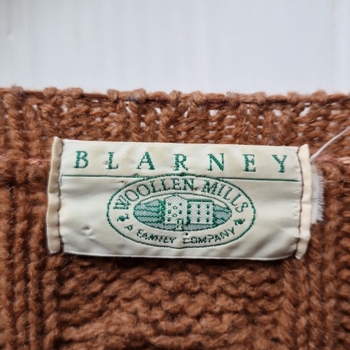 426 - A Blarney Woollen Mills Irish cable-knit wool cardigan, in rust-brown, with round neckline, long sle... 