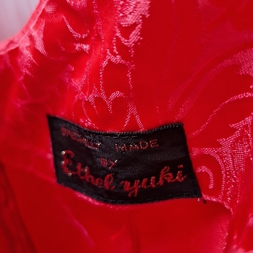 428 - 2 Chinese-style red floral brocade garments, comprising a sleeveless dress and a long jacket with ma... 