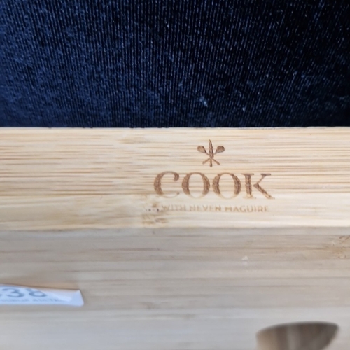 438 - A group of household items including a Cook by Kelvin Haguire bamboo serving board, a Finland souven... 