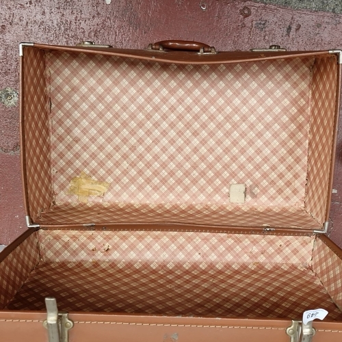 449 - A vintage brown suitcase with stitched exterior, twin clasps and central handle, the interior lined ... 