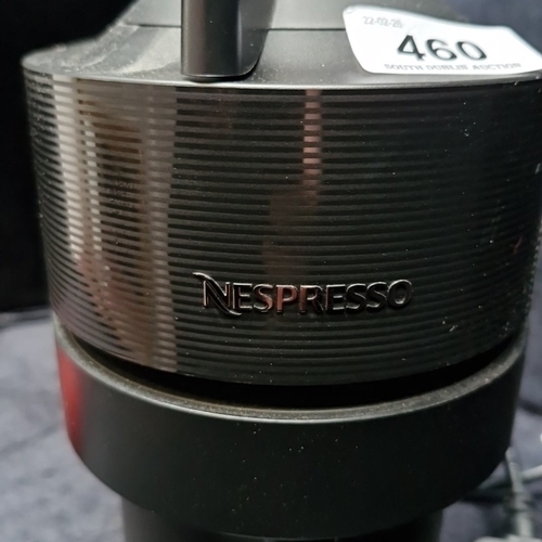 460 - A Nespresso capsule coffee machine, in black with ribbed upper band, hinged head, detachable water r... 