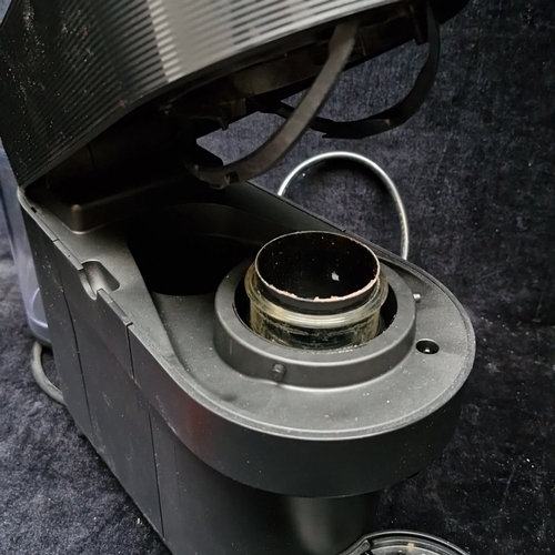 460 - A Nespresso capsule coffee machine, in black with ribbed upper band, hinged head, detachable water r... 