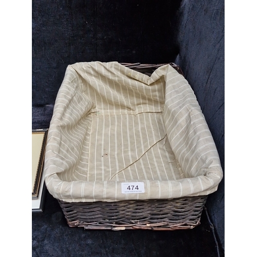 474 - A group of framed prints and a wicker basket with striped fabric liner, including coloured views of ... 