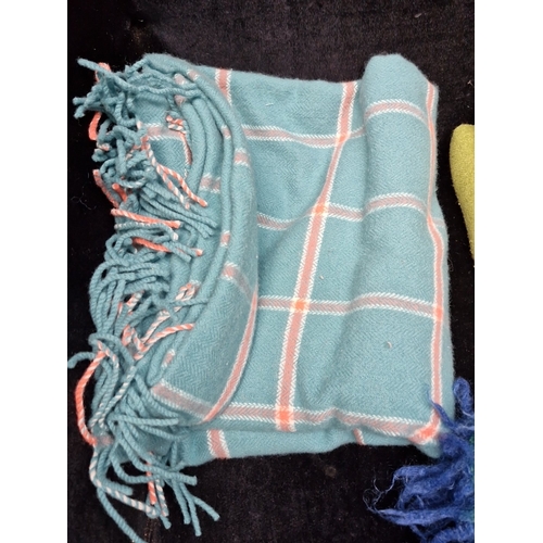 475 - A group of clean woollen textiles, comprising a teal checked fringed throw, a green woven blanket, a... 