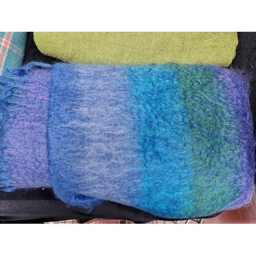 475 - A group of clean woollen textiles, comprising a teal checked fringed throw, a green woven blanket, a... 