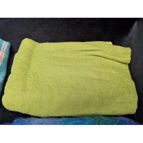 475 - A group of clean woollen textiles, comprising a teal checked fringed throw, a green woven blanket, a... 