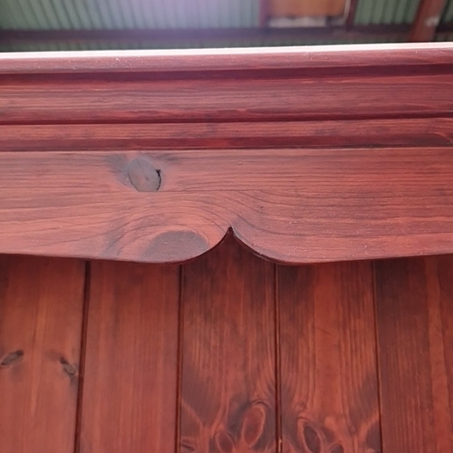 482 - A tall pine open bookcase, the moulded cornice with scalloped apron above a boarded back and five ad... 