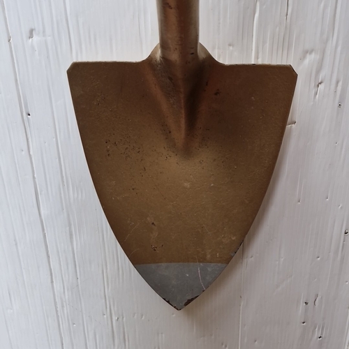 483 - A long-handled spade, the metal blade painted in a gold tone with a pointed steel cutting edge, on a... 