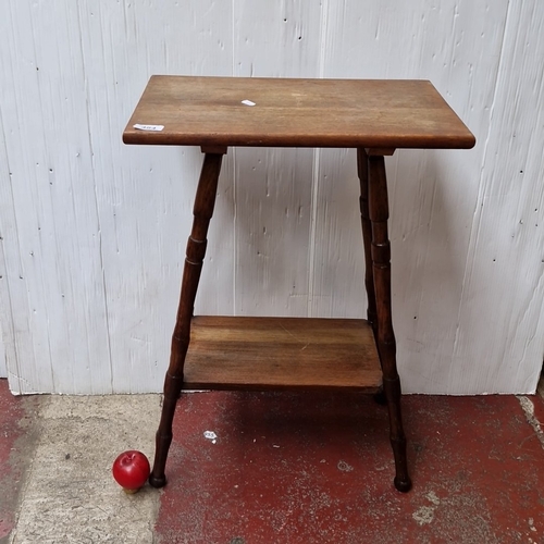 484 - A small oak occasional table, the rectangular top with rounded corners raised on turned tapering leg... 