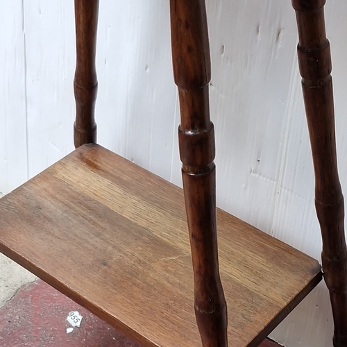 484 - A small oak occasional table, the rectangular top with rounded corners raised on turned tapering leg... 