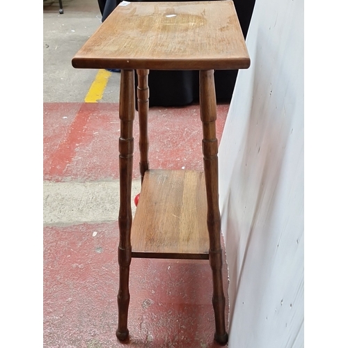 484 - A small oak occasional table, the rectangular top with rounded corners raised on turned tapering leg... 