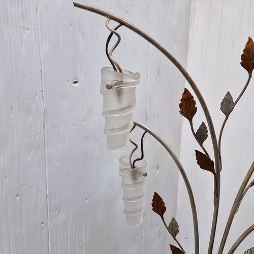 487 - A sculptural metal floor lamp with five arched arms issuing frosted spiral glass shades, enriched wi... 