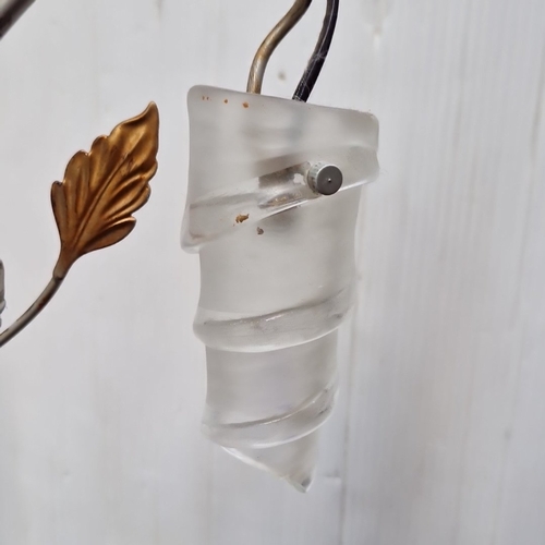 487 - A sculptural metal floor lamp with five arched arms issuing frosted spiral glass shades, enriched wi... 