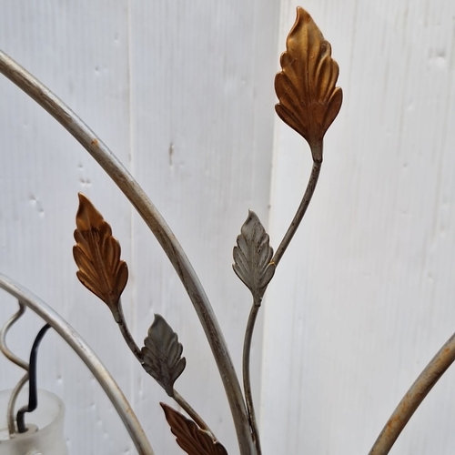 487 - A sculptural metal floor lamp with five arched arms issuing frosted spiral glass shades, enriched wi... 