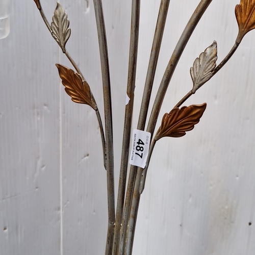 487 - A sculptural metal floor lamp with five arched arms issuing frosted spiral glass shades, enriched wi... 