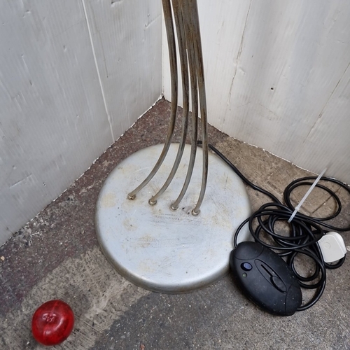 487 - A sculptural metal floor lamp with five arched arms issuing frosted spiral glass shades, enriched wi... 