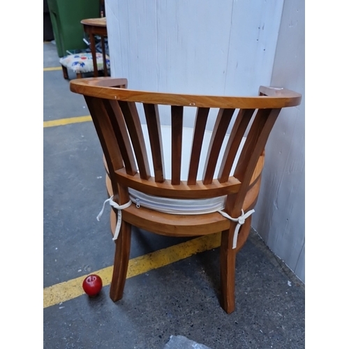 496 - A bentwood armchair with wraparound horseshoe back and vertical spindle splats, upholstered seat pad... 