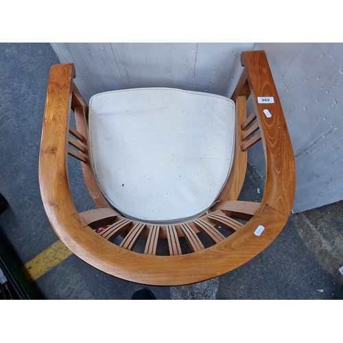 496 - A bentwood armchair with wraparound horseshoe back and vertical spindle splats, upholstered seat pad... 
