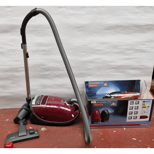 419 - A Miele Complete C3 “Cat & Dog” PowerLine canister vacuum cleaner, in maroon, with hose, telescopic ... 