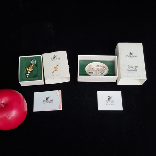 143 - Two Swarovski Crystal Memories from the retired line. Lot includes a statuette of a sewing machine a... 