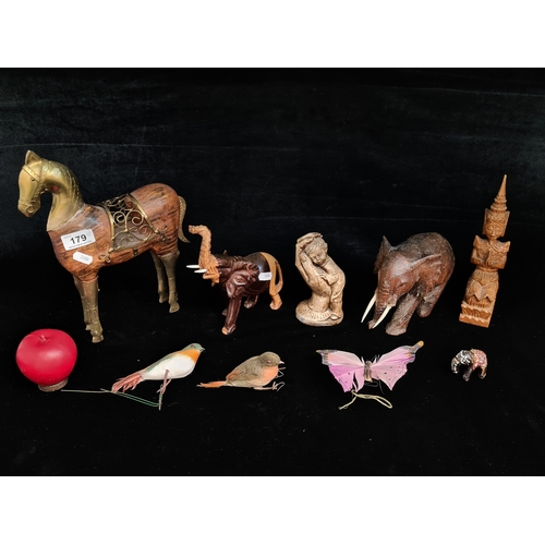 179 - An interesting mixed lot of items including a wooden and brass figure of a horse, two carved elephan... 