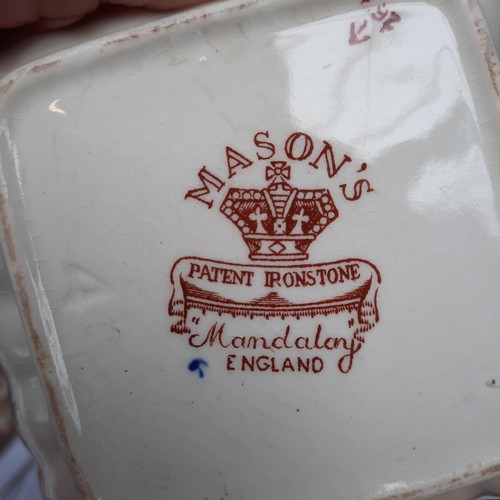 394 - A mixed lot of items including three bud vases, a Masons ring dish, and miniature lidded vanity jars... 