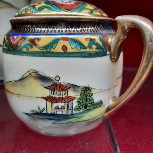 391 - A vintage Noritake porcelain tea / coffee set from Japan. Pieces feature hand painted and gilded wor... 