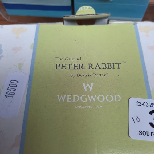 398 - A mixed lot of items including a brand new Wedgewood Christening Collection Peter Rabbit Cup, A Nost... 