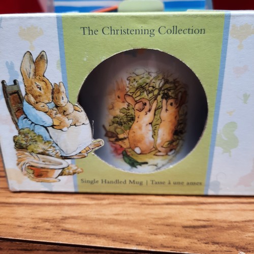 398 - A mixed lot of items including a brand new Wedgewood Christening Collection Peter Rabbit Cup, A Nost... 