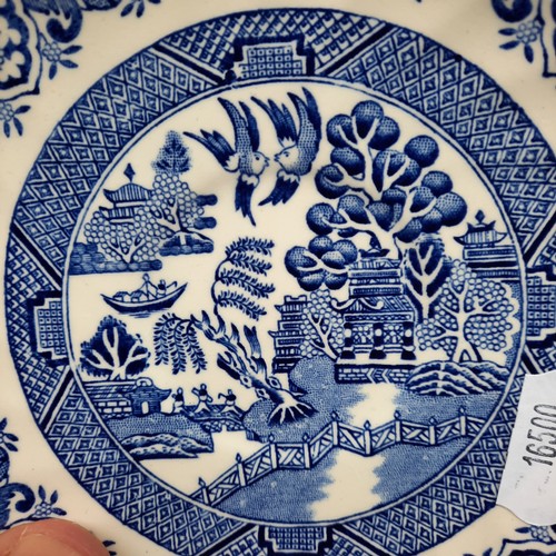 416 - A group of Churchill Blue Willow pattern blue-and-white tableware, including cups and saucers, dinne... 